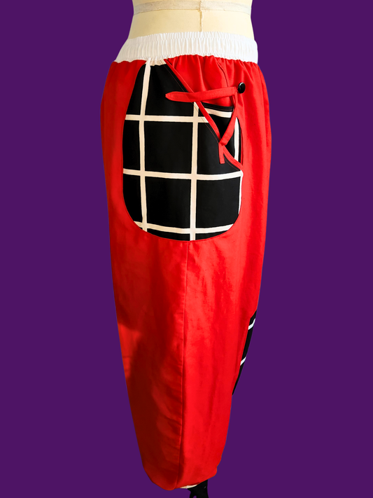 Red pants with a black and white checkered pocket on a purple background
