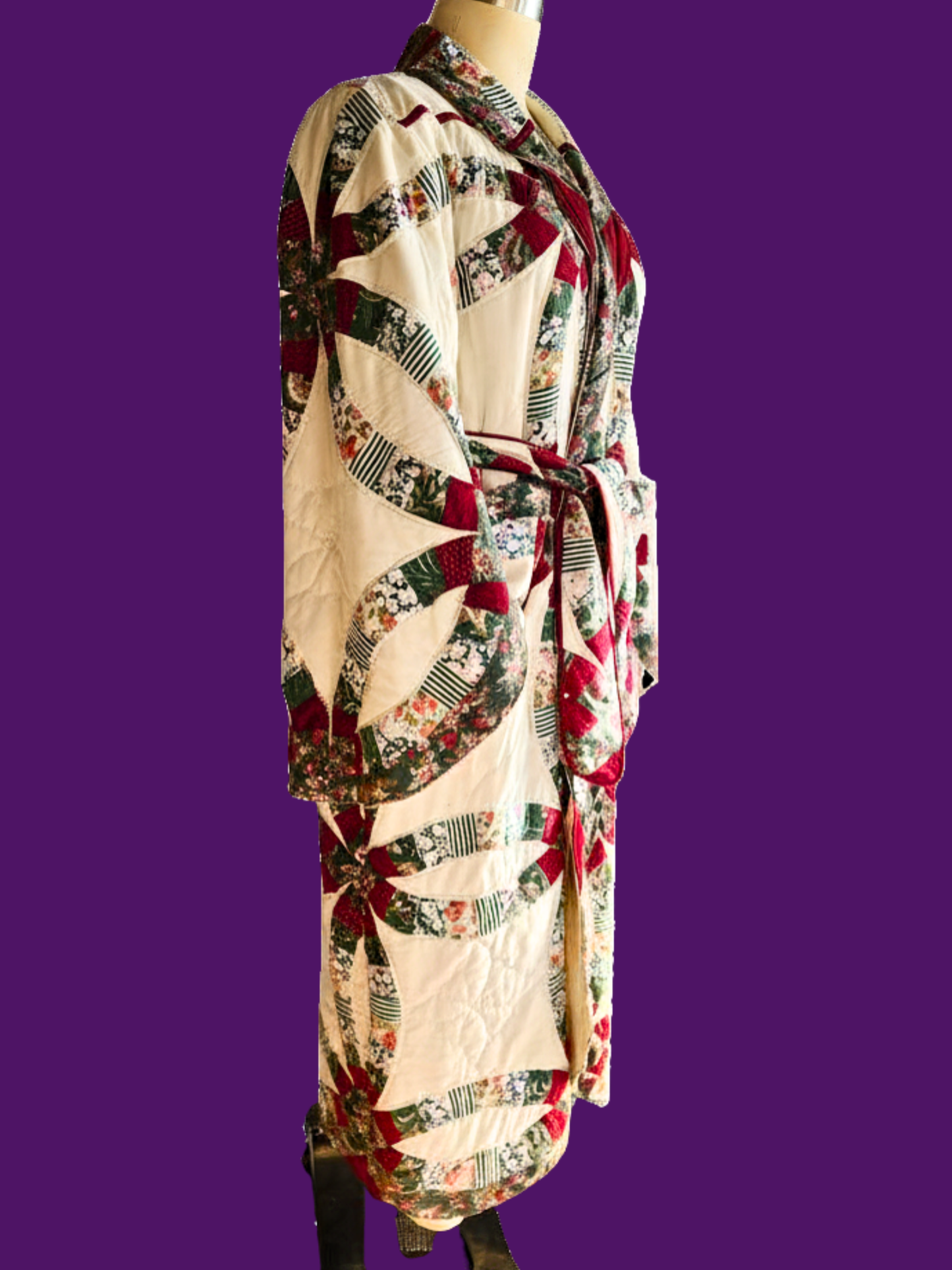 Patchwork robe on a mannequin against a purple background