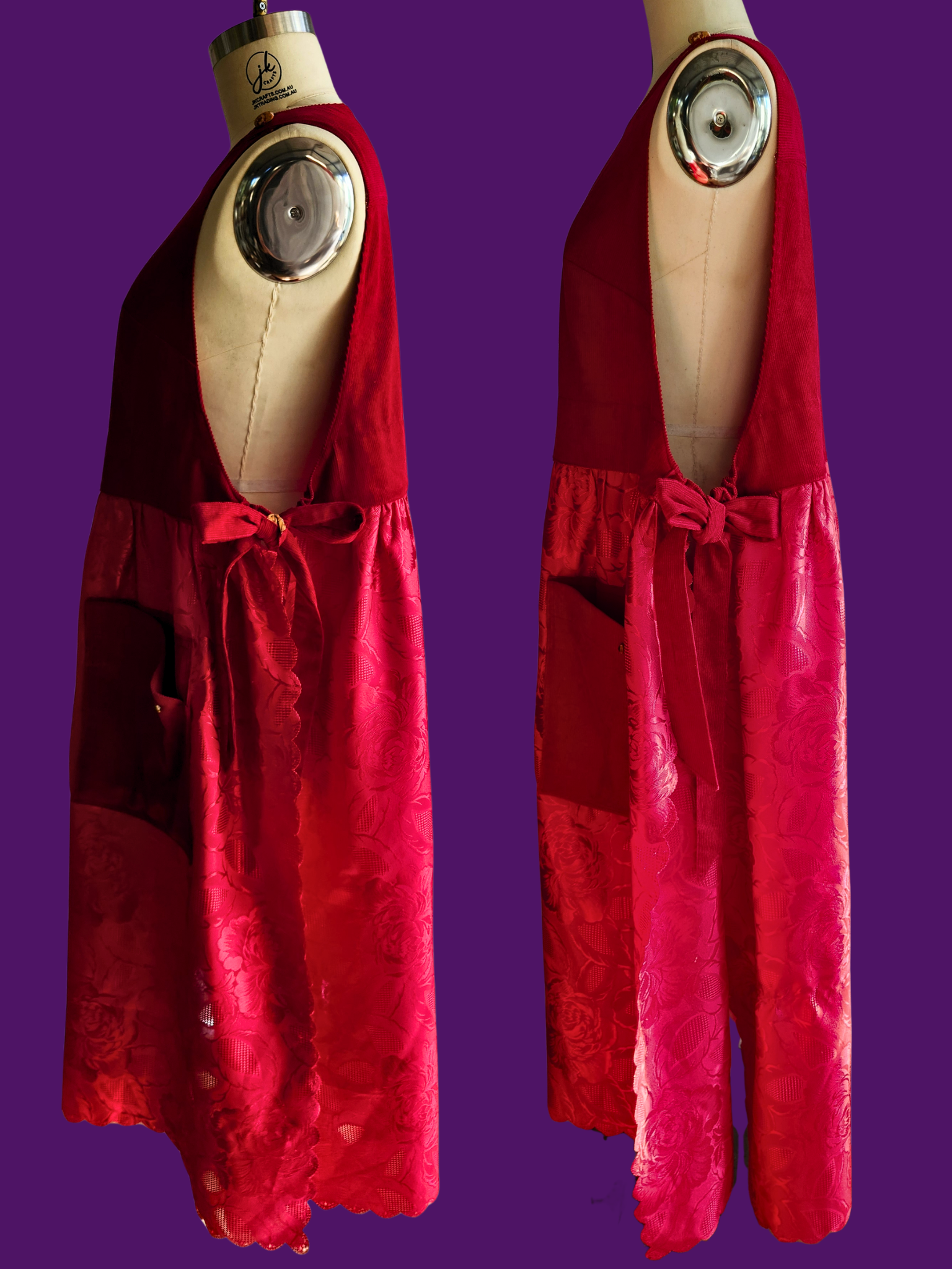 Red lace dress on a mannequin against a purple background