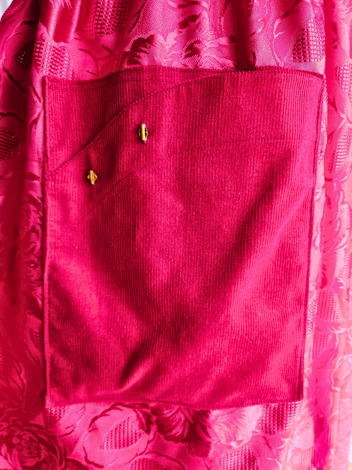Close-up of a red garment with floral patterned background