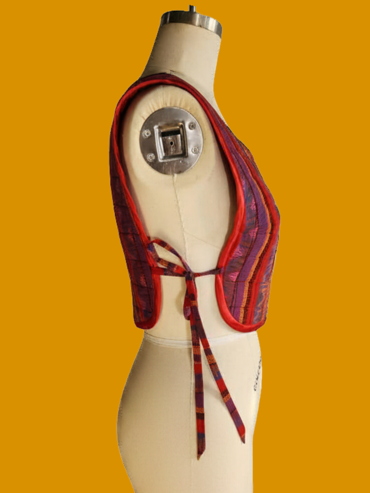 Textile shoulder bag on a mannequin against an orange background
