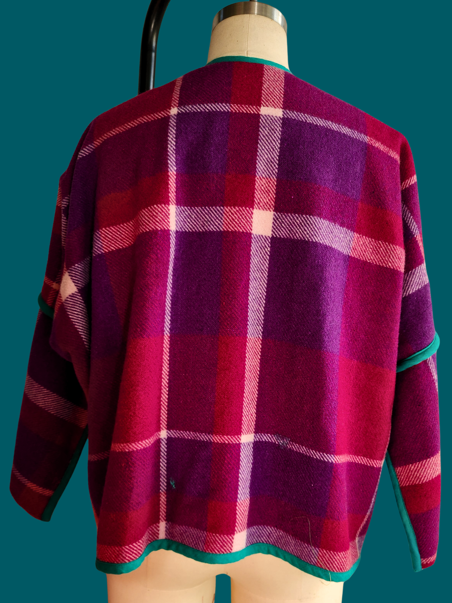 pink plaid jacket back on a size 12 model on a teal background