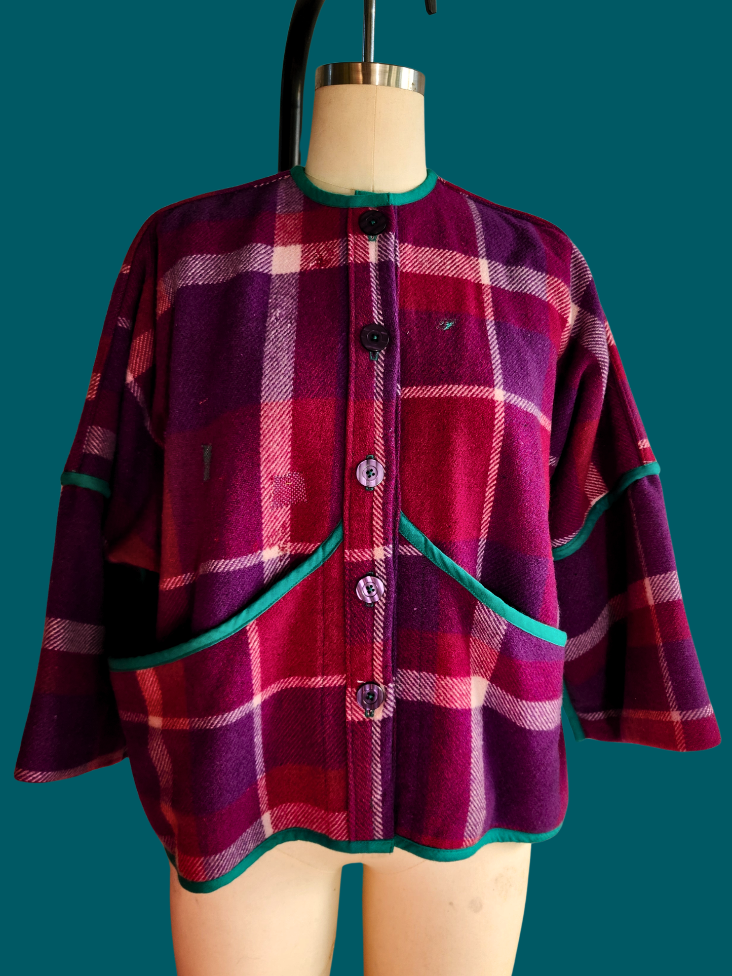 pink plaid jacket on a size 12 model on a teal background