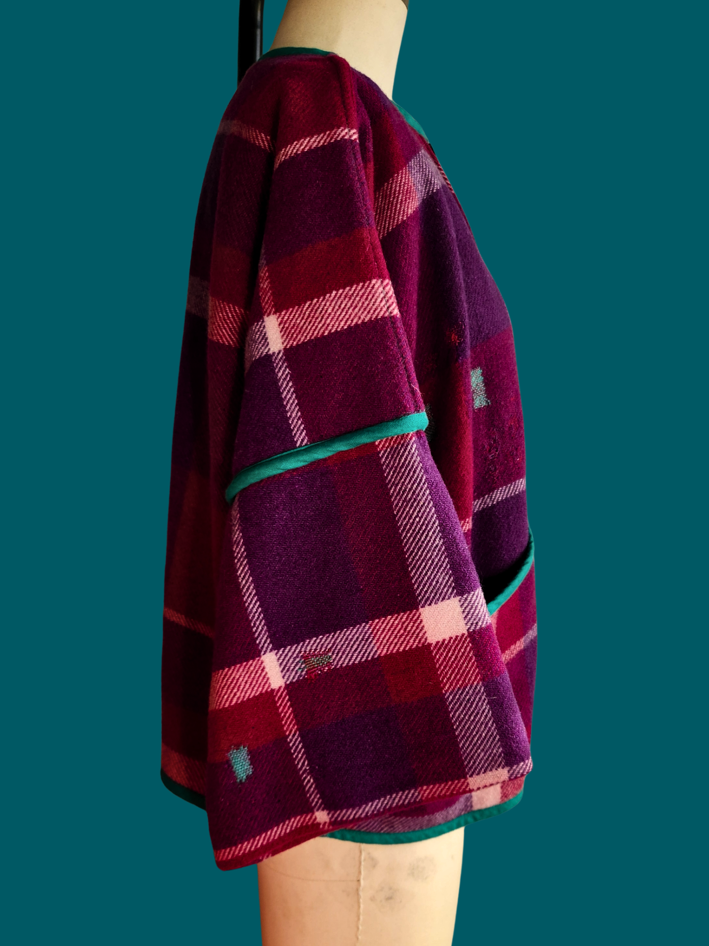 right side of pink plaid jacket on size 12 model on teal background