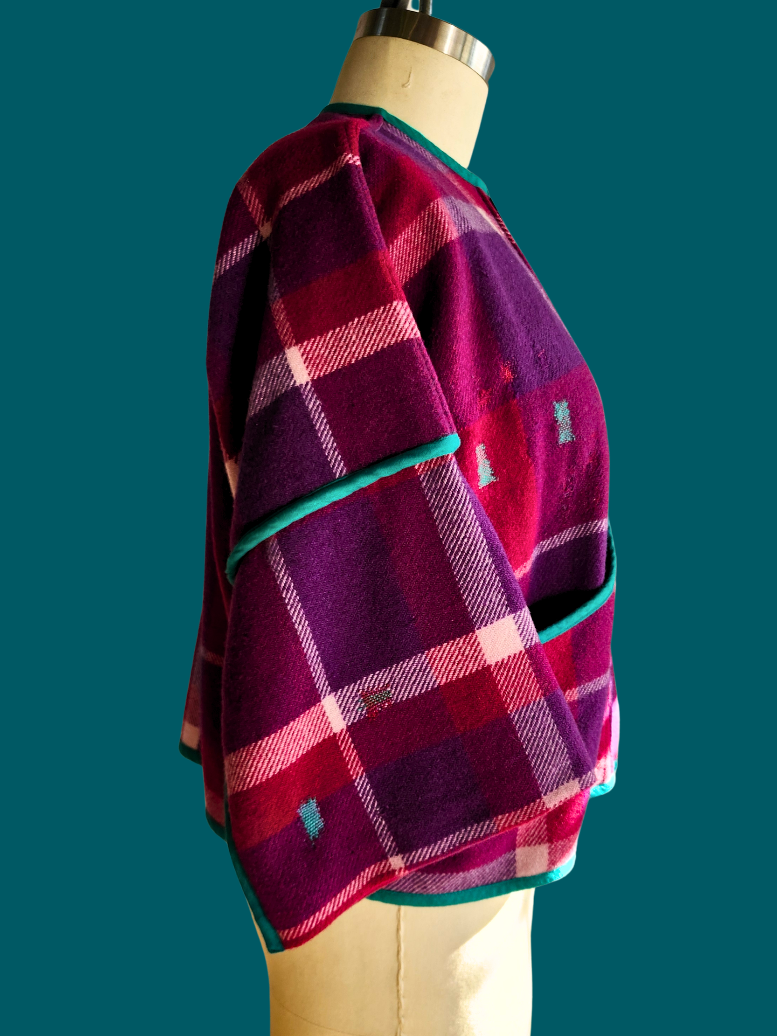 right side of pink plaid jacket on size 18 model on teal background