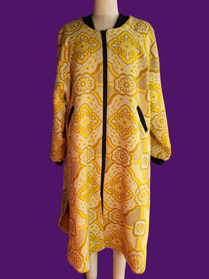 Yellow patterned coat on a mannequin against a purple background