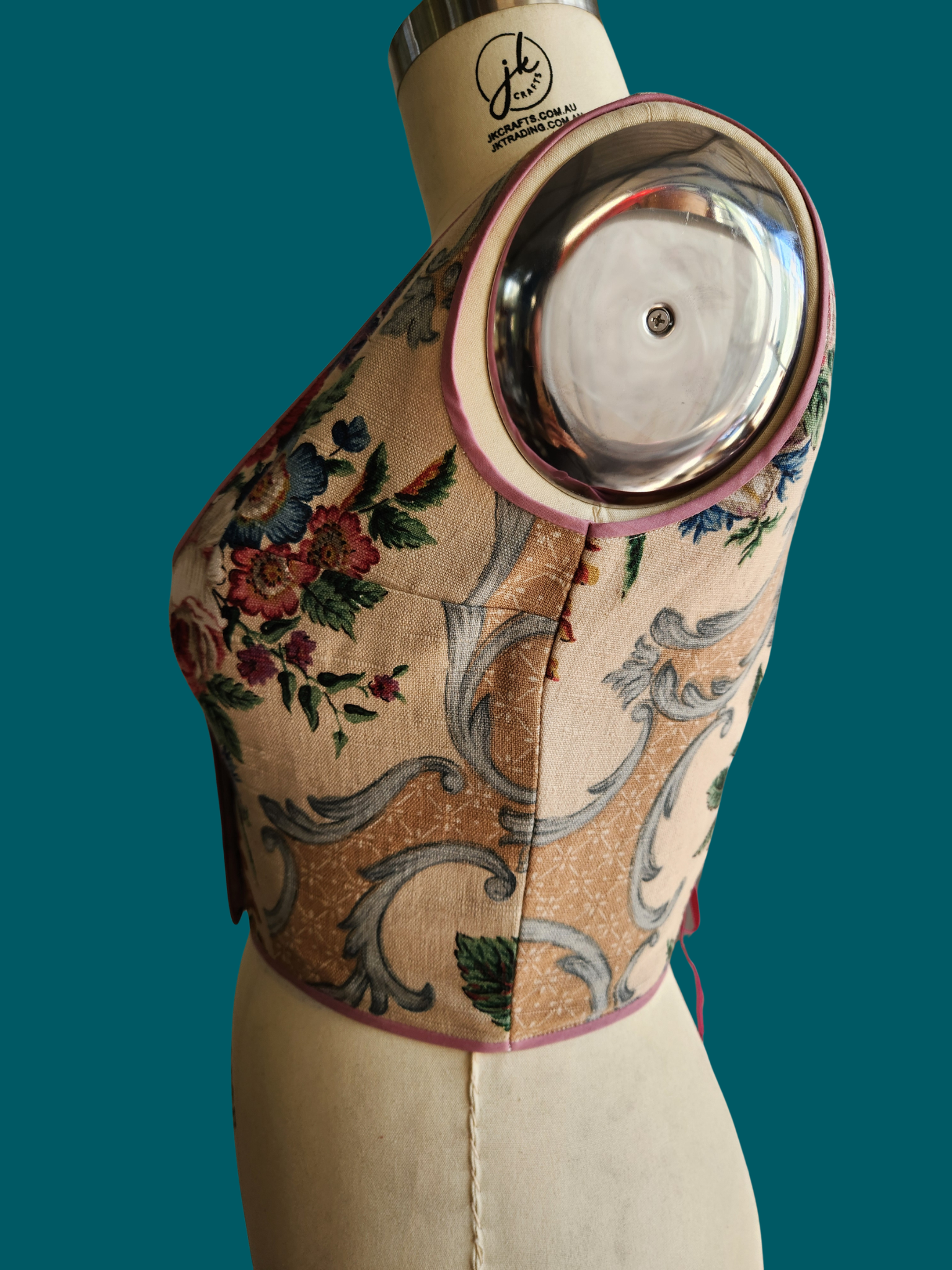 vest with floral and paisley patterns on a green background