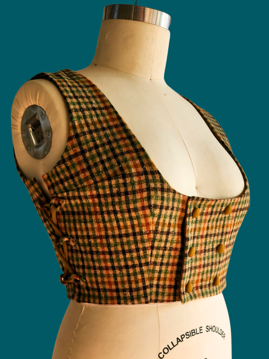 Plaid vest on a mannequin with a green background