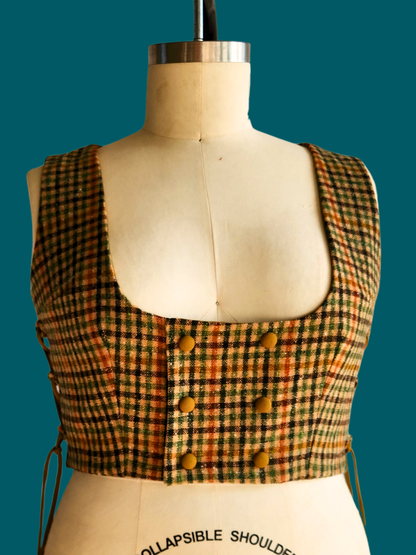 Plaid vest on a mannequin with a teal background