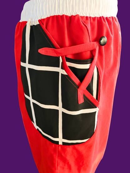 Red pants with a black and white grid pattern on a purple background