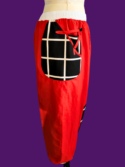 Red pants with a black and white checkered pocket on a purple background
