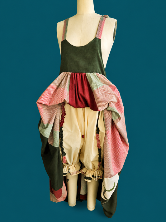 Mannequin wearing a colorful, layered dress against a blue background